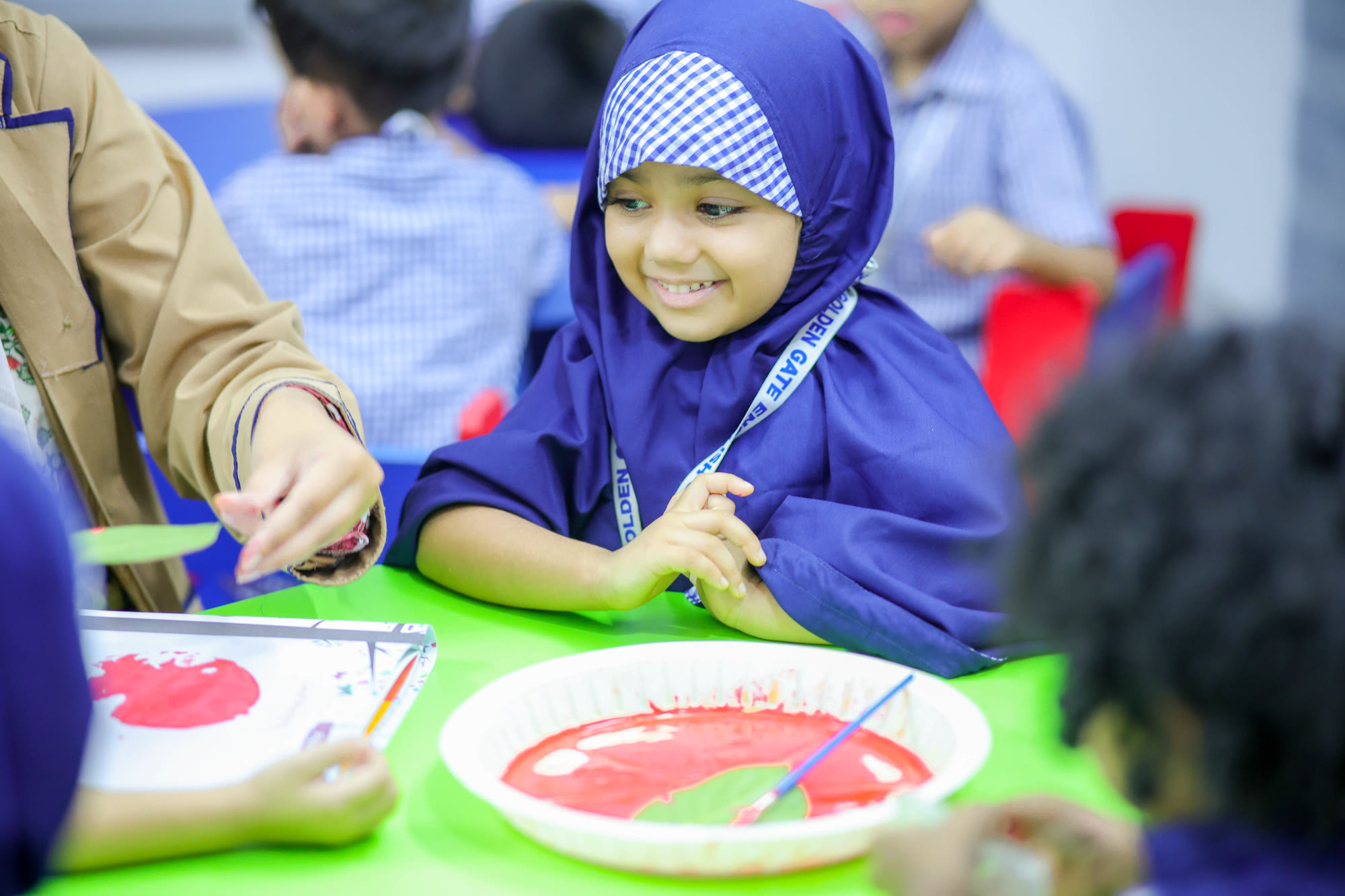 Teacher supporting young students during classroom activity